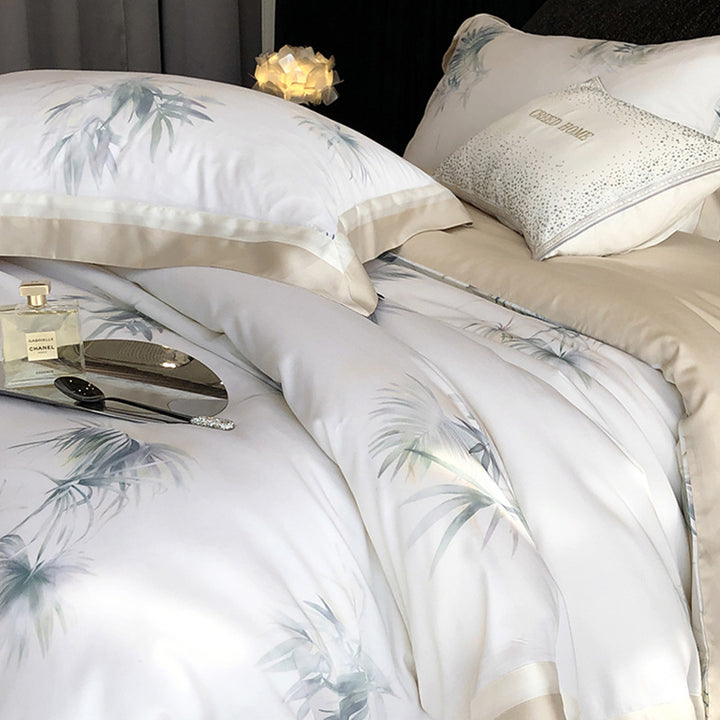 Luxurious cotton satin bedding set with delicate leaf print, contrasting hem and fine piping