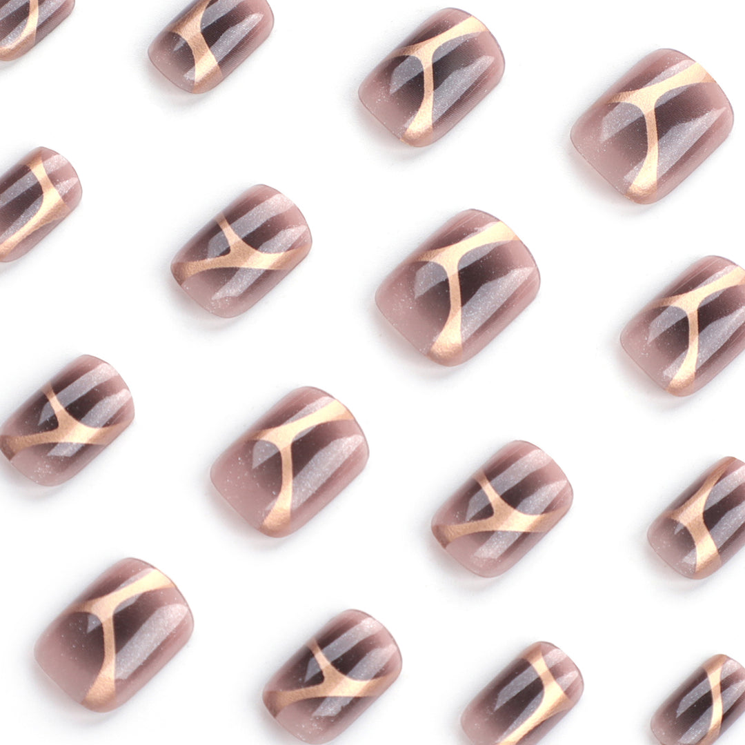 Artificial nail art with elegant metallic design and glitter accents Kalsten