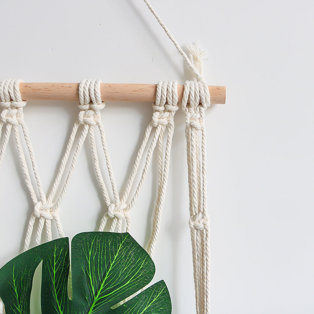 Elegant macramé wall hanging with decorative tassels and wooden frame