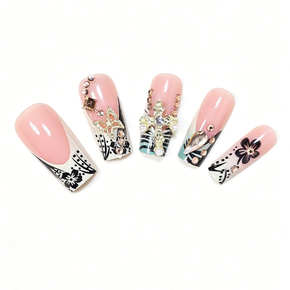 Artistic Stiletto Nail Design with Floral Accents and Gems Kalsten