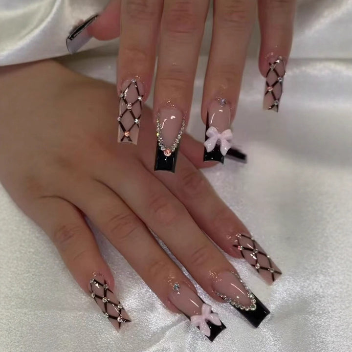 Artificial nail set with glamorous rhinestone and bow accents Kalsten