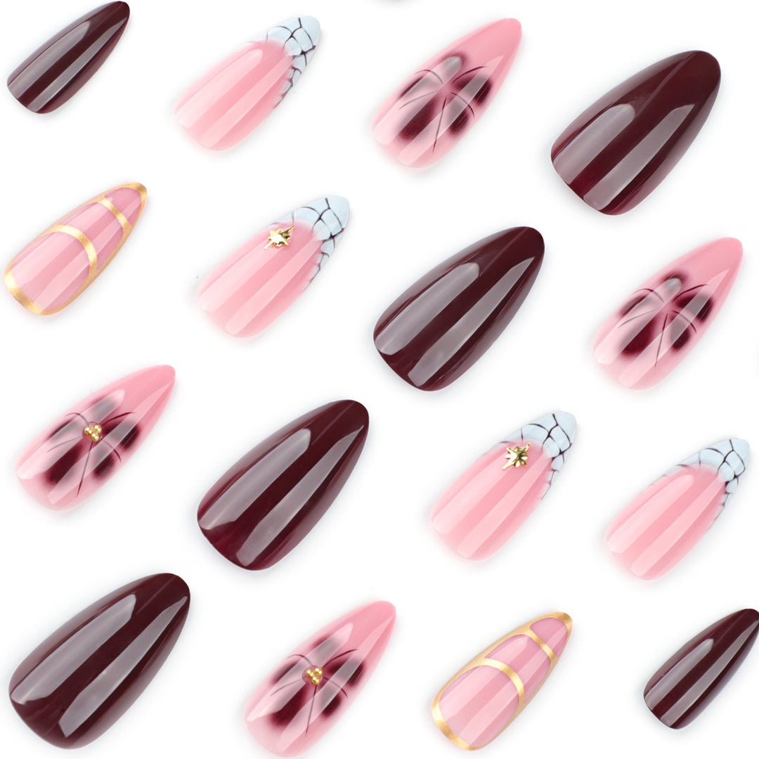 Artful Stiletto nails with gold accents and decorative floral designs Kalsten