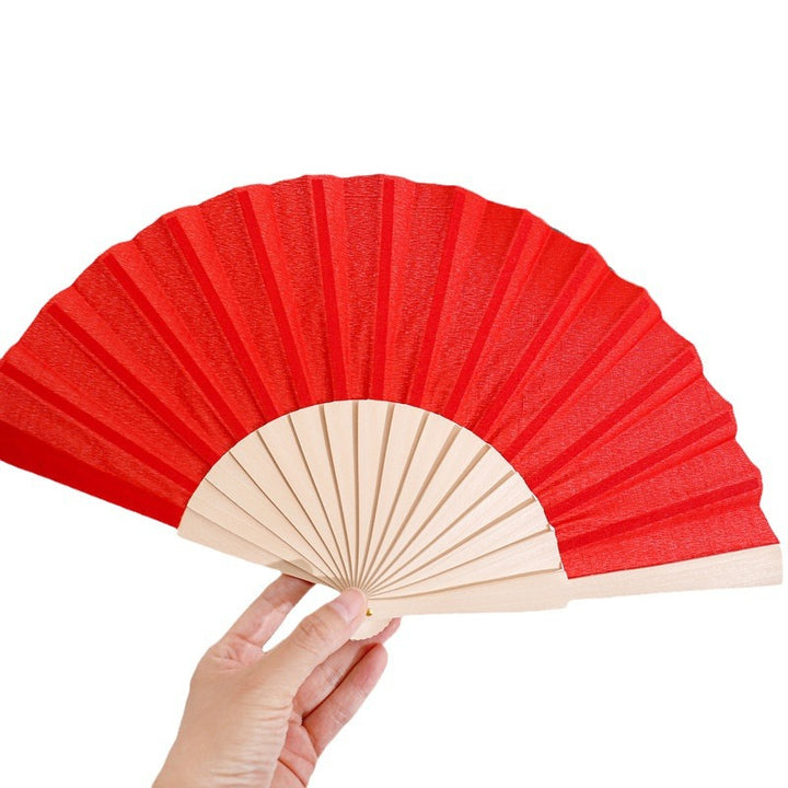 Ladies folding hand fan made of airy material with intricate folds Kalsten