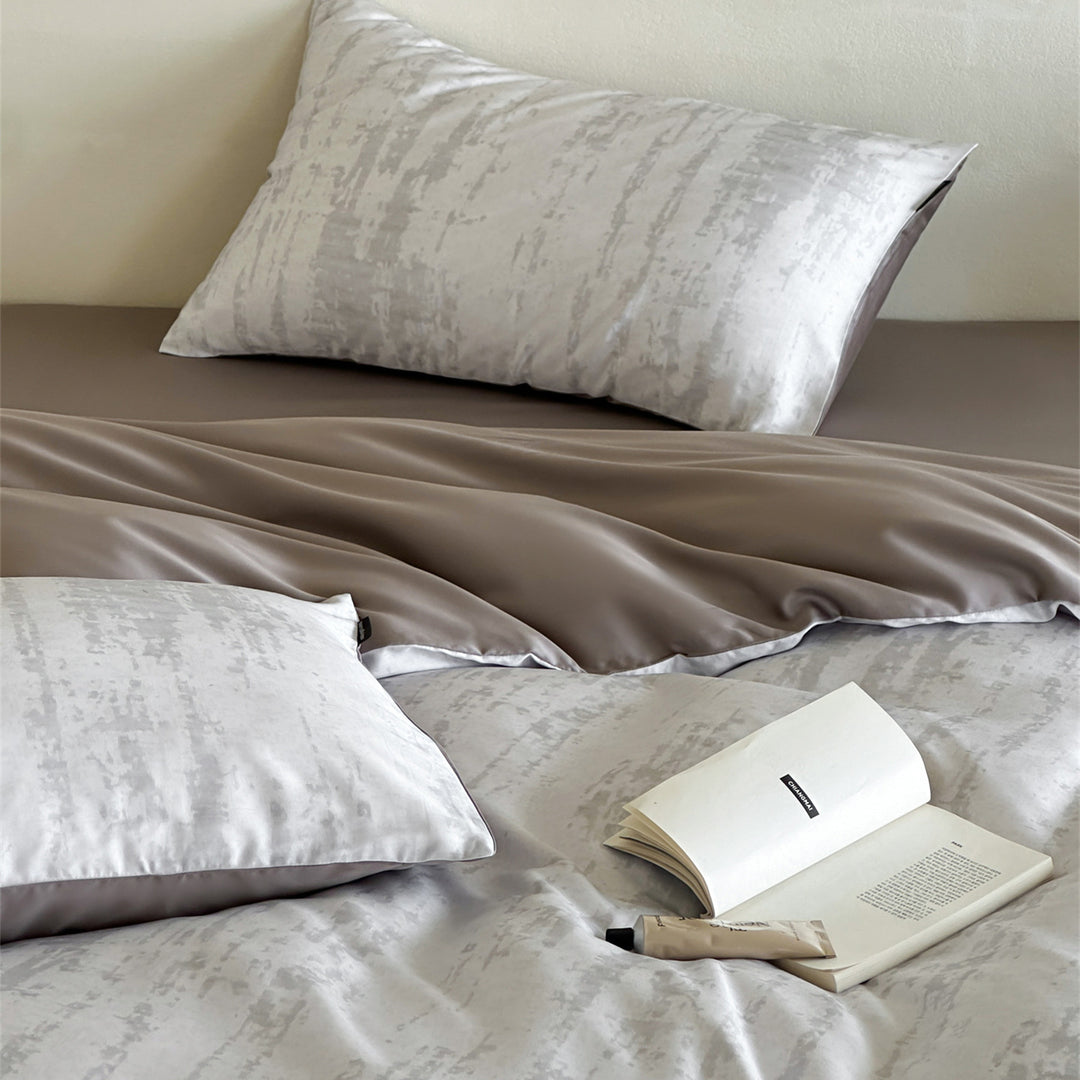 Luxurious satin bedding set with floral watercolor print, ruffled edges and reversible function