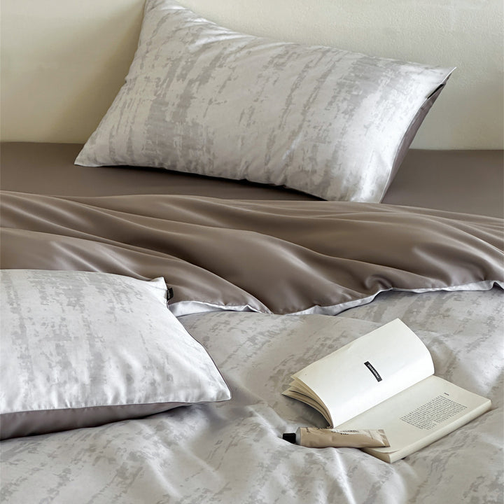 Luxurious satin bedding set with floral watercolor print, ruffled edges and reversible function