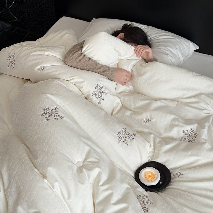 Quilted all-season duvet with floral embroidery and button detailing
