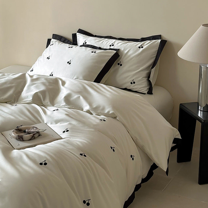Luxurious satin bedding set with cherry embroidery and contrasting trim