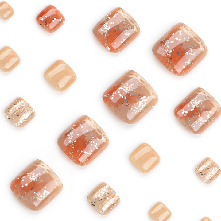 Artistic toenail design with glitter and golden accents Kalsten