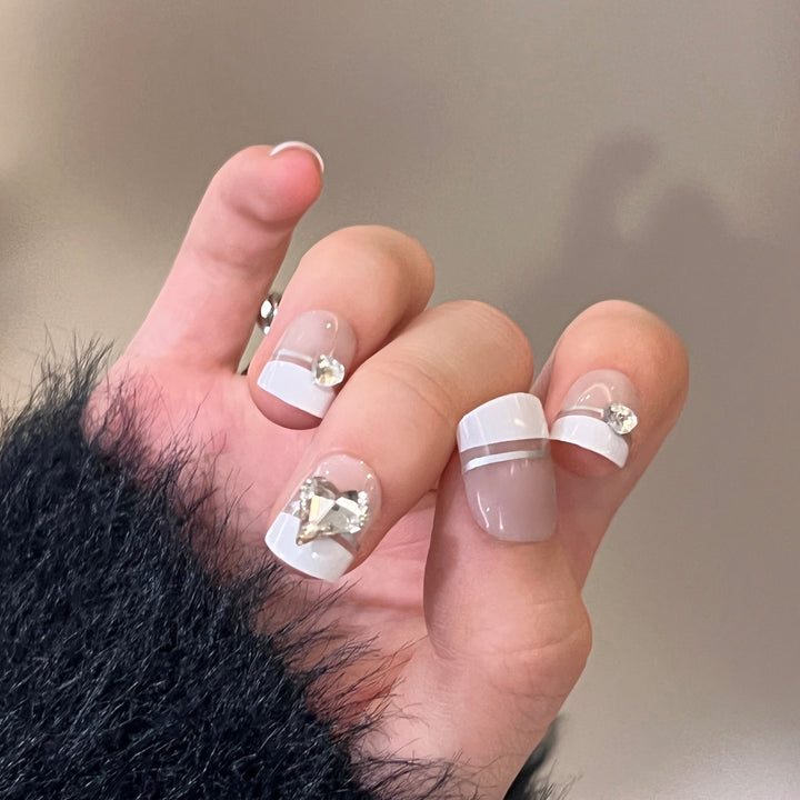 Elegant Nail Art with Glitter Accents and Jewelry Details Kalsten