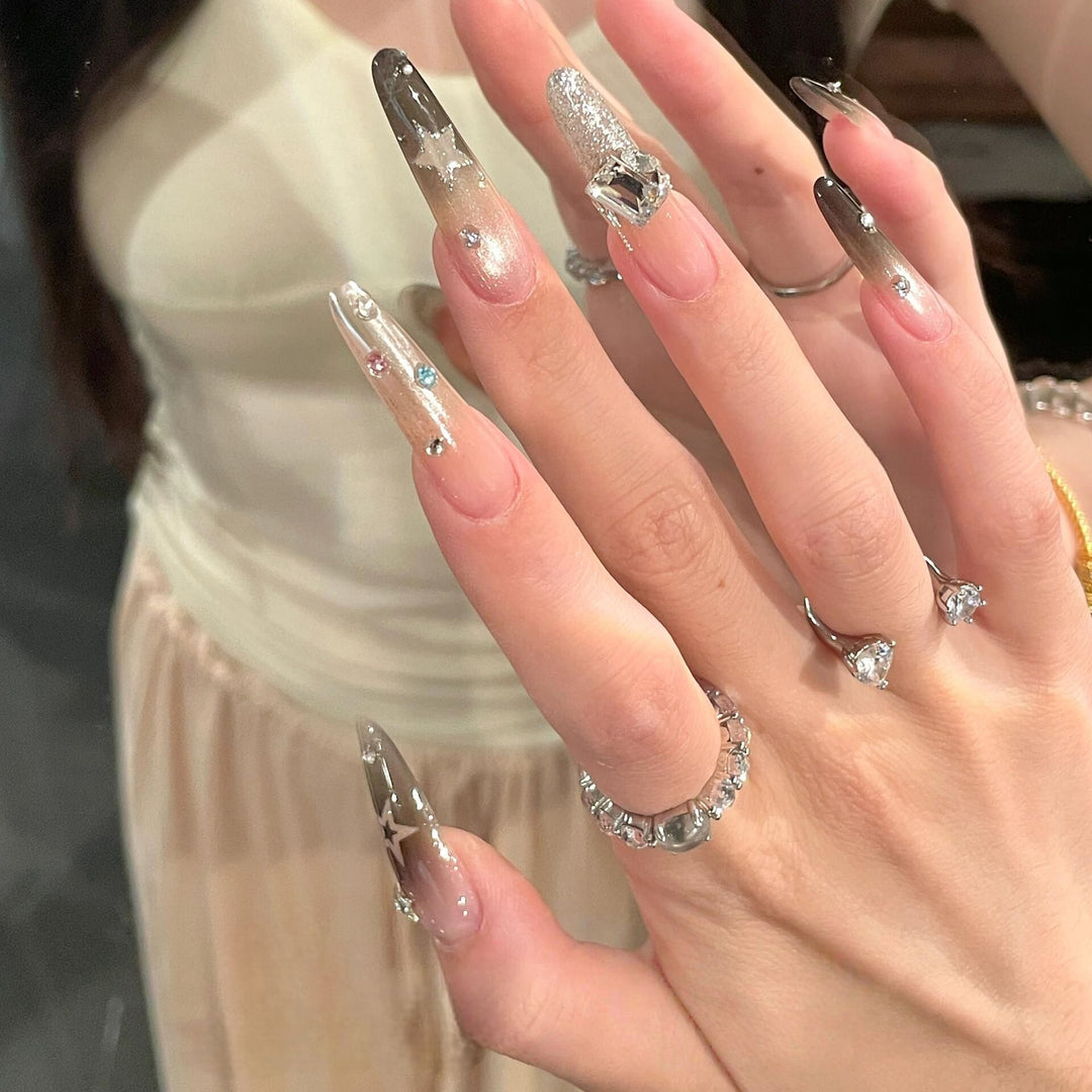 Glamorous artificial nails with sparkling rhinestone and star designs Kalsten