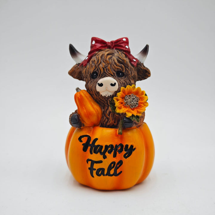 Funny decorative figure of a Highland cow in pumpkin costume Kalsten