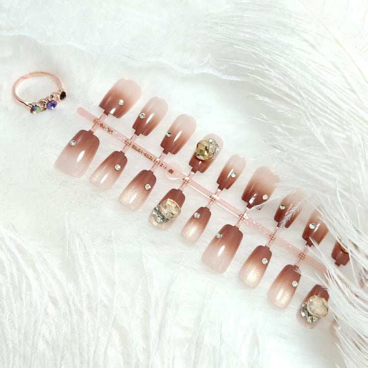 Artificials nails in elegant ombre style with rhinestone embellished applications Kalsten