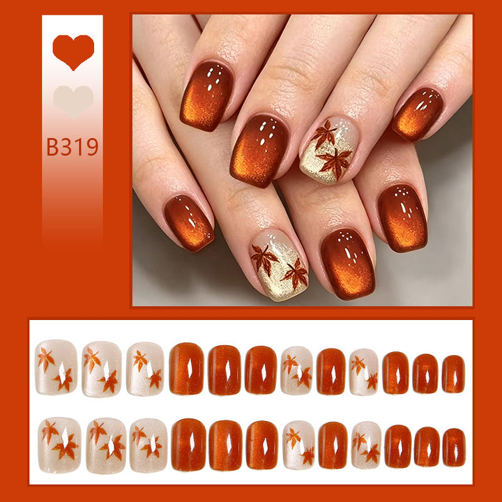 Artificial nails with glamorous ombre design and autumn leaf applications Kalsten
