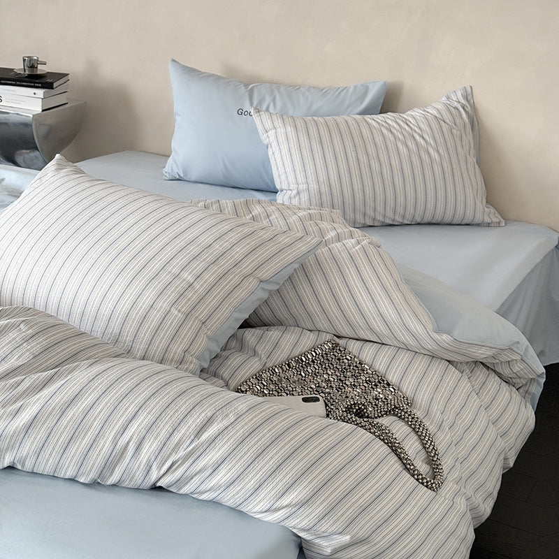 Modern bedding set made of breathable cotton muslin with a fine stripe pattern and reversible function