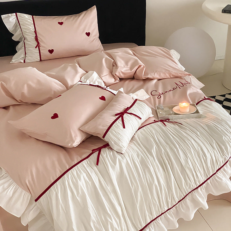 Romantic bedding set with ruffles, heart embroidery and luxurious satin look