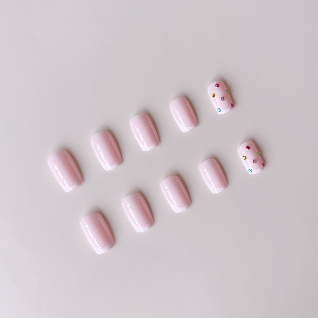 Nail art set with elegant French tips and sparkling rhinestone embellishments Kalsten
