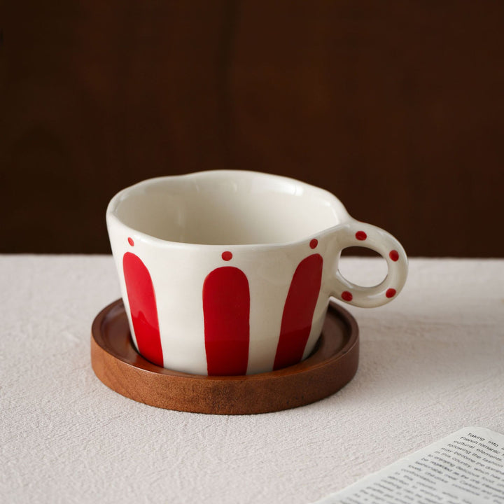 Ceramic espresso cup with round wooden coaster and handcrafted stripe pattern