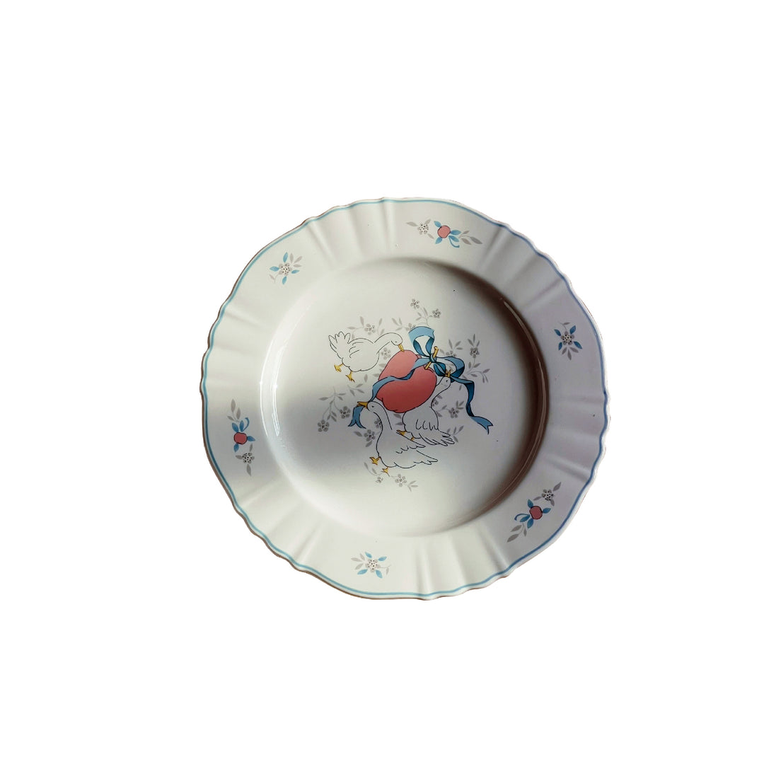 Decorative porcelain soup plate with ribbed edge and duck motif