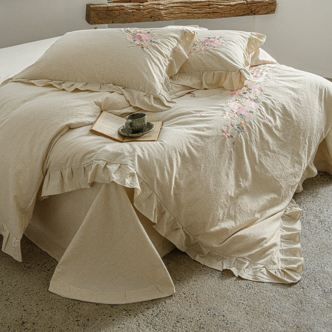 Embroidered linen-look bedding set with ruffle and floral embroidery detail