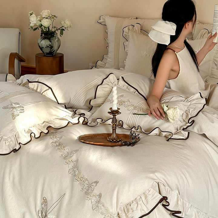 Luxurious bedding set made of cotton satin with embroidered butterfly motif, frill and decorative piping