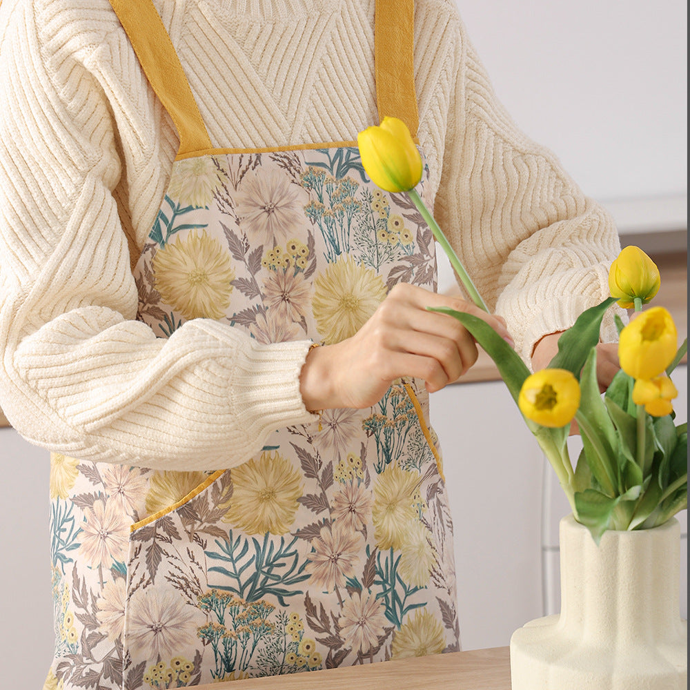 Bib apron made of sturdy cotton blend with adjustable neck strap and patch front pockets