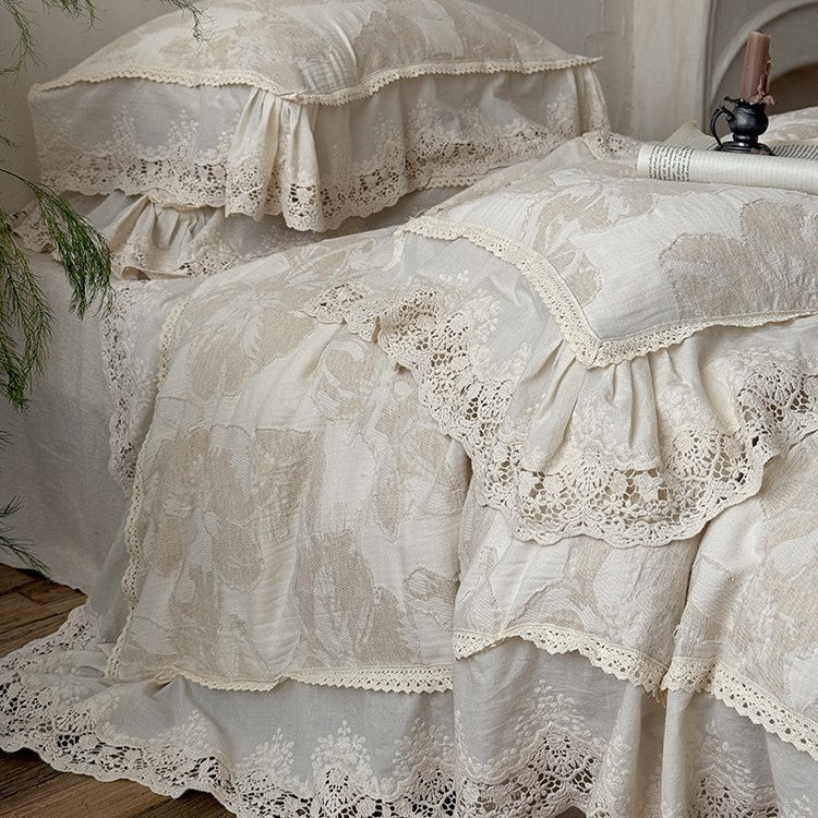 Vintage-inspired cotton-linen bedding set with large floral pattern, ruffle, and lace appliqué