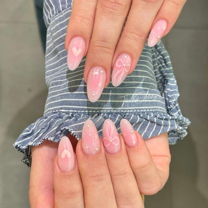 Artistic Heart-Embellished Stiletto Nail Enhancements