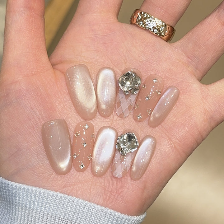 Elegant artificial nails with shimmering effects and rhinestone accents Kalsten