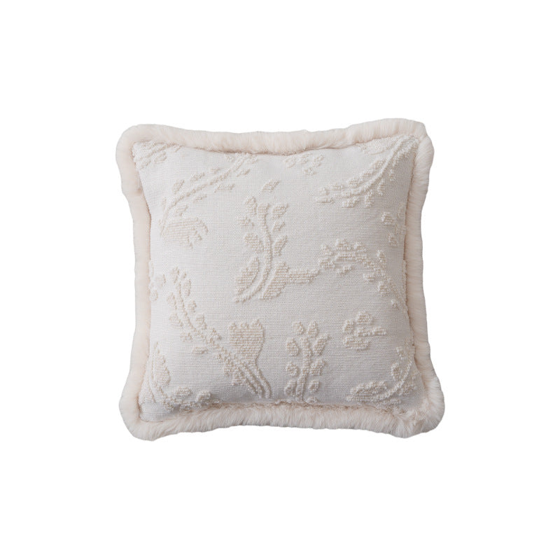 Square decorative pillow with embossed circular relief and soft faux fur edging