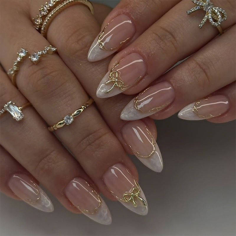 Artificial nails with elegant tip decorations and golden accents Kalsten