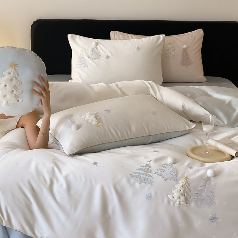 Luxurious satin bedding set with winter pine embroidery and pompom applications
