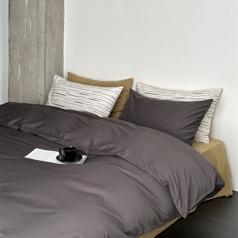 Modern satin bedding set with quilted look and patterned pillowcases