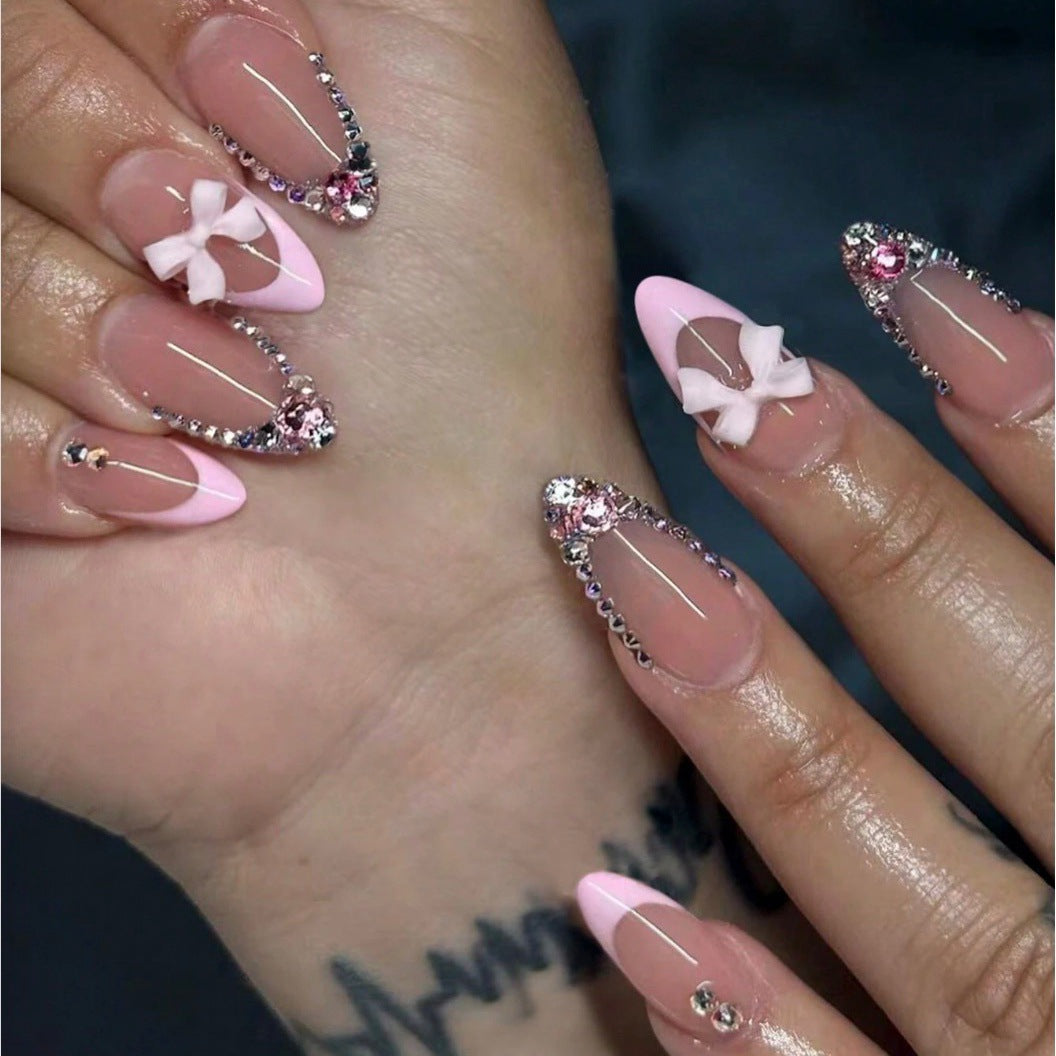 Acrylic nail set with elegant 3D bows and sparkling rhinestone embellishments Kalsten