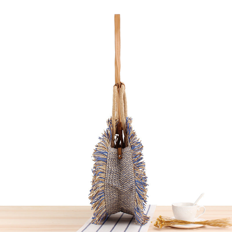 Round bag with fringe decoration Made of woven material Kalsten