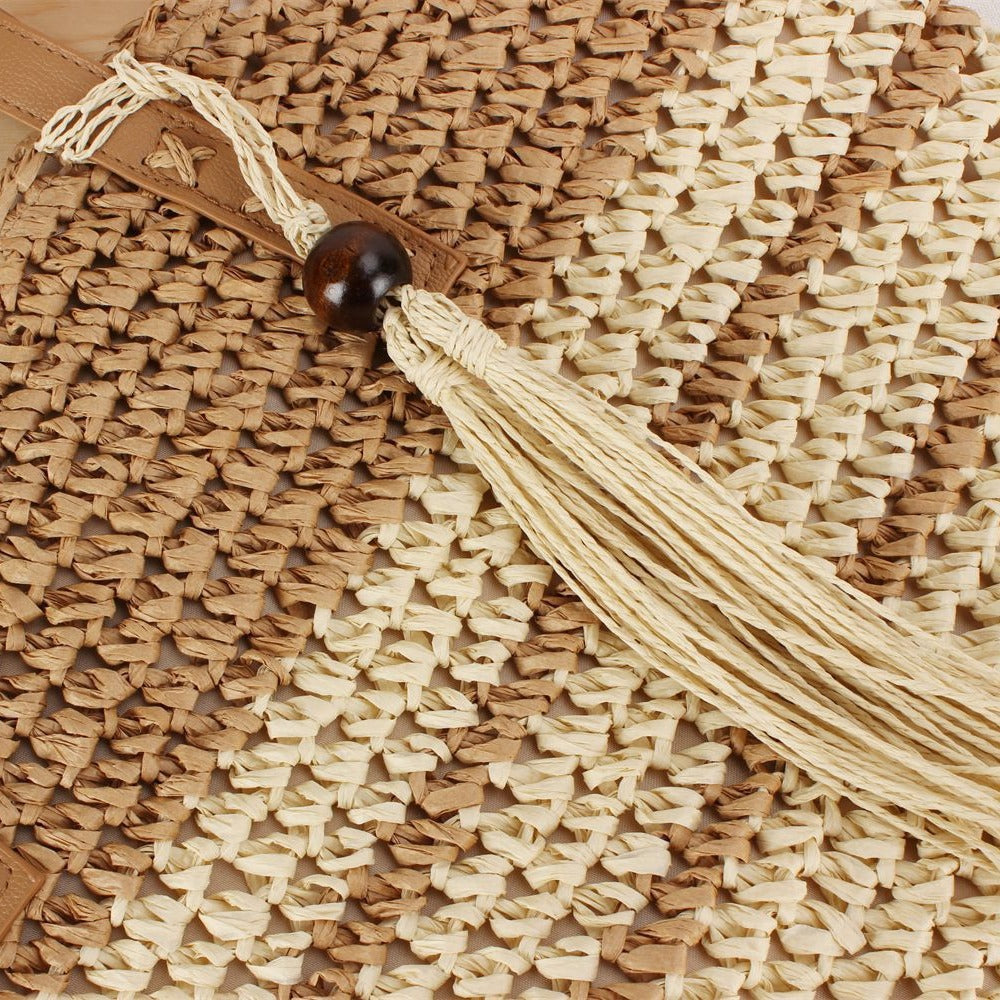 Handbag made of braided natural material with decorative tassel pendant Kalsten