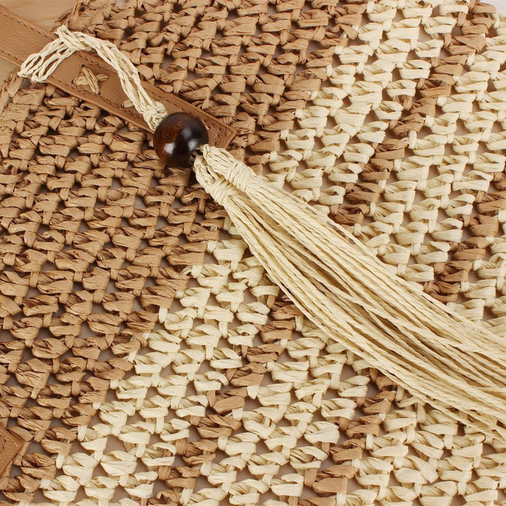 Handbag made of braided natural material with decorative tassel pendant Kalsten