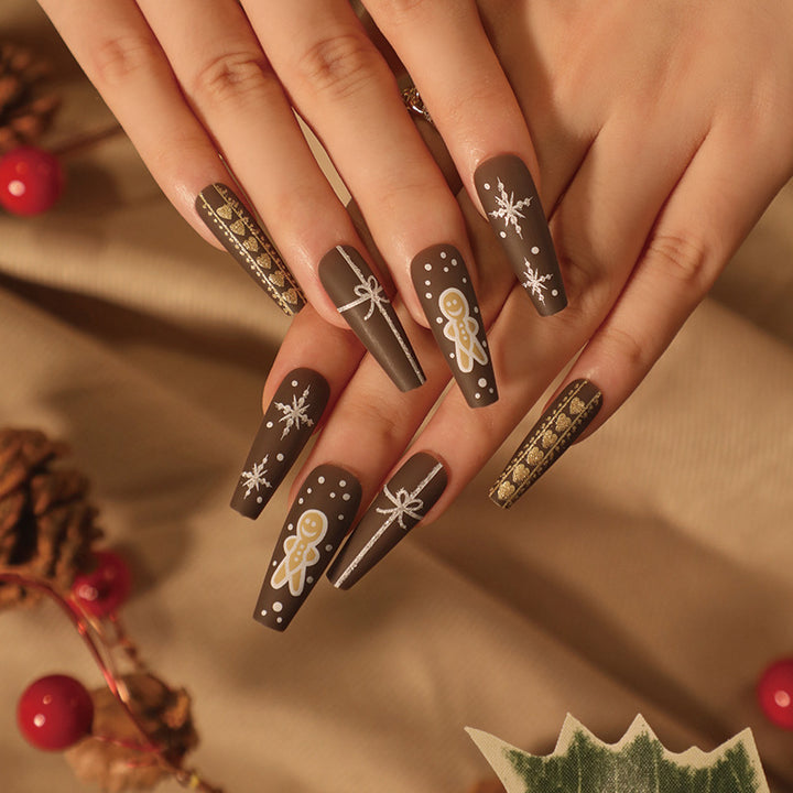 Artificial nail art with festive gingerbread design Kalsten