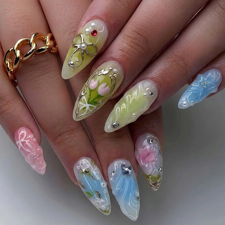 Creative nail set with hand-drawn floral patterns and glitter accents Kalsten