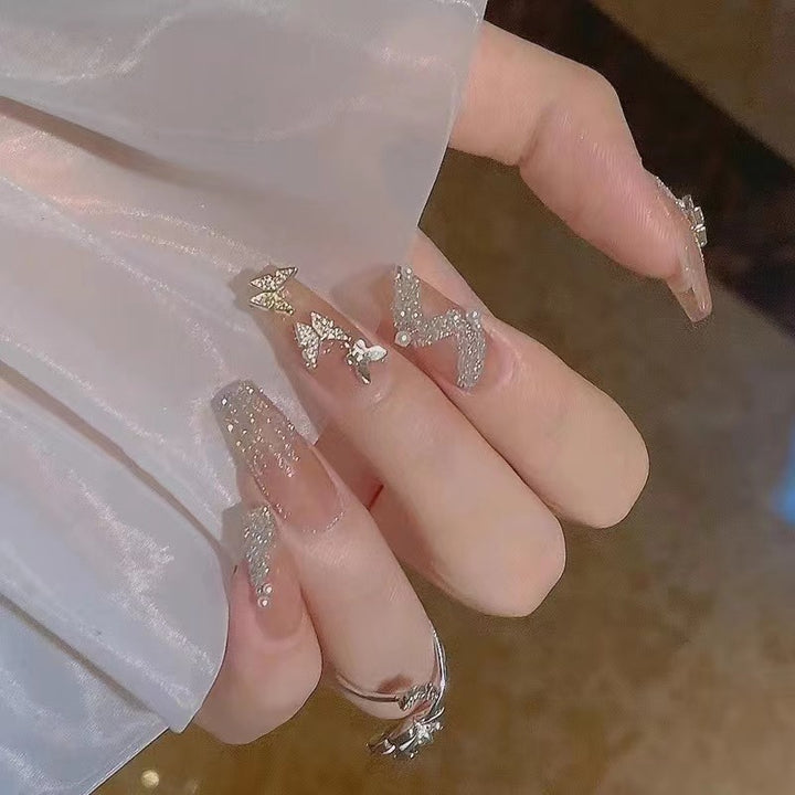 Glamorous nail art with rhinestone and butterfly elements Kalsten