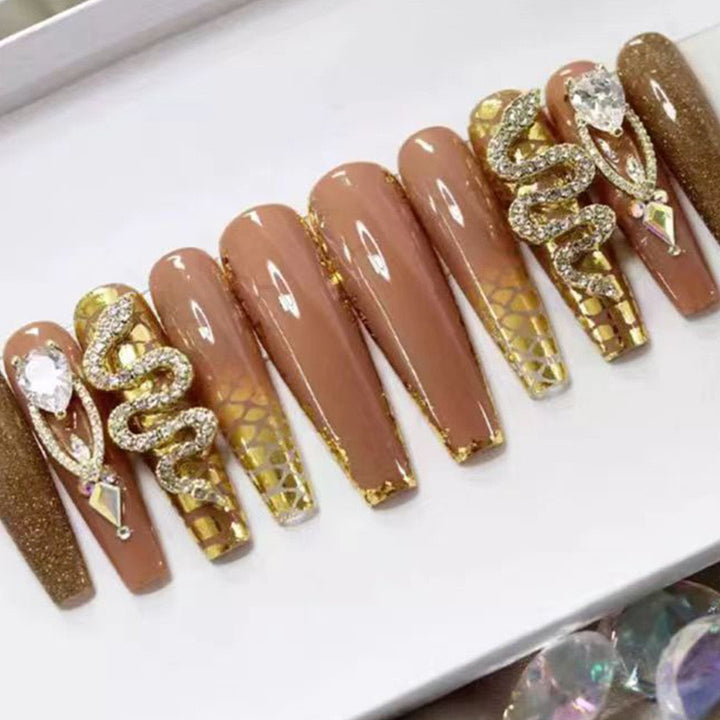 Exclusive stiletto artificial nails with glitter and jewelry accents Kalsten