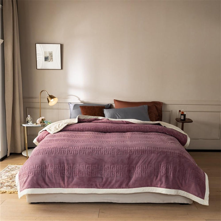 Reversible quilted comforter with structured box stitching and cotton trim