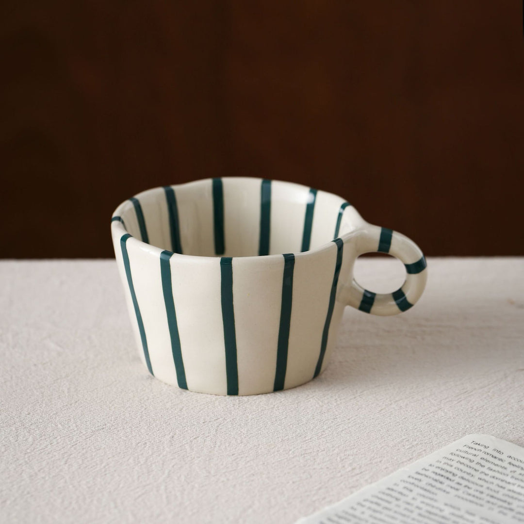 Handmade ceramic mug with ergonomic handle and wavy rim