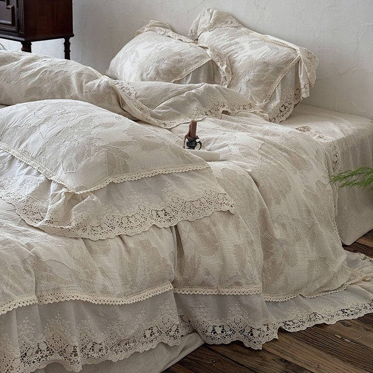 Vintage-inspired cotton-linen bedding set with large floral pattern, ruffle, and lace appliqué