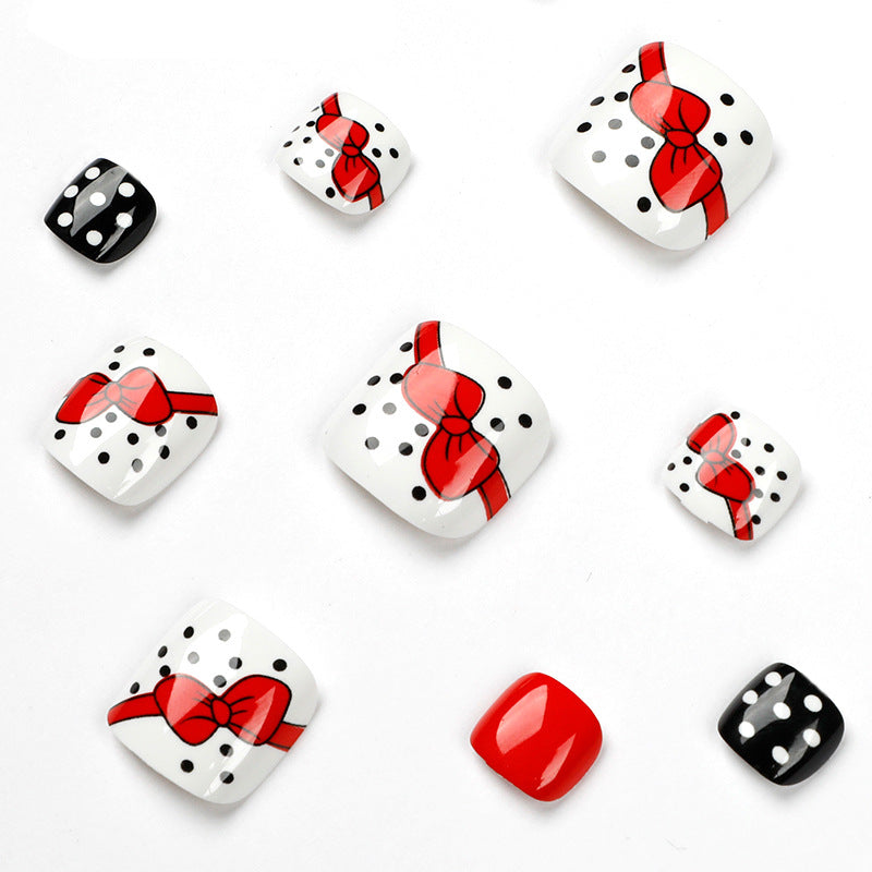 Artful toenail design with elegant bow motifs Kalsten