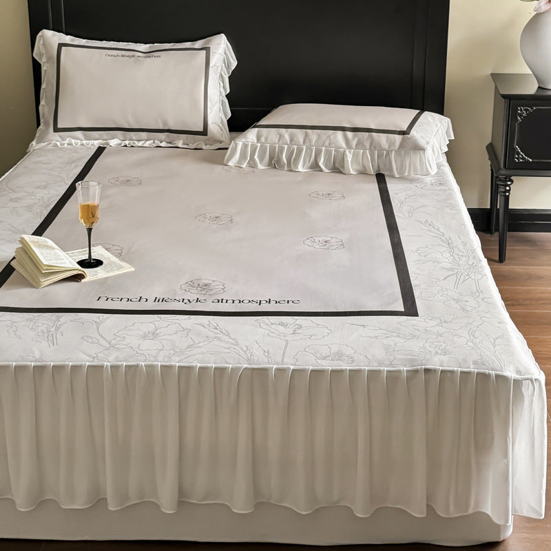 Bedding set with ruffled bed skirt, floral printed center piece and frill pillow