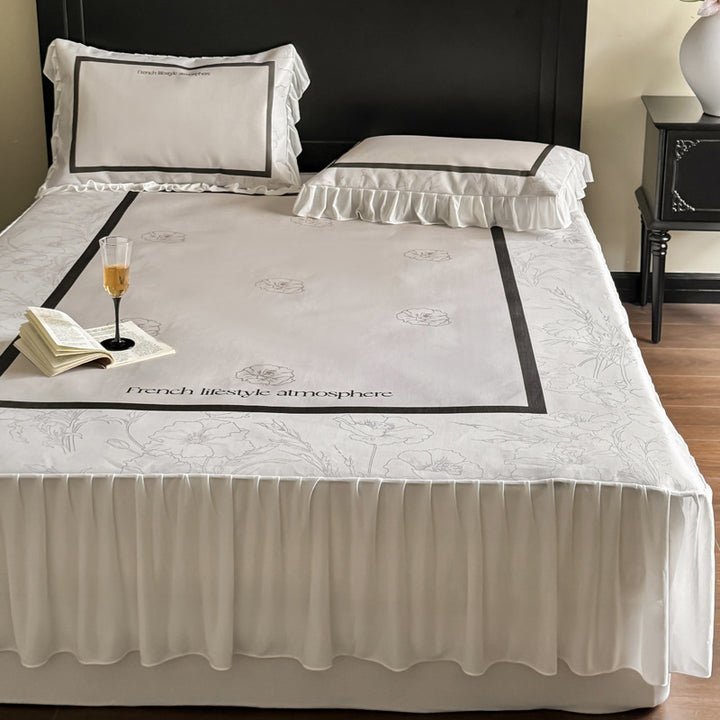 Bedding set with ruffled bed skirt, floral printed center piece and frill pillow