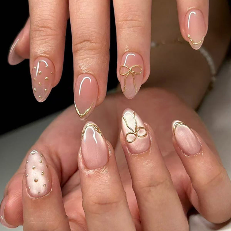 Artful nail extensions with elegant golden accents Kalsten