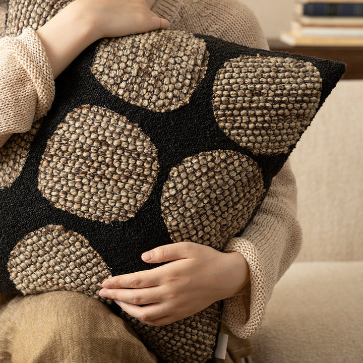 Decorative cushion cover made of textured bouclé weaving technique with raised round appliqués