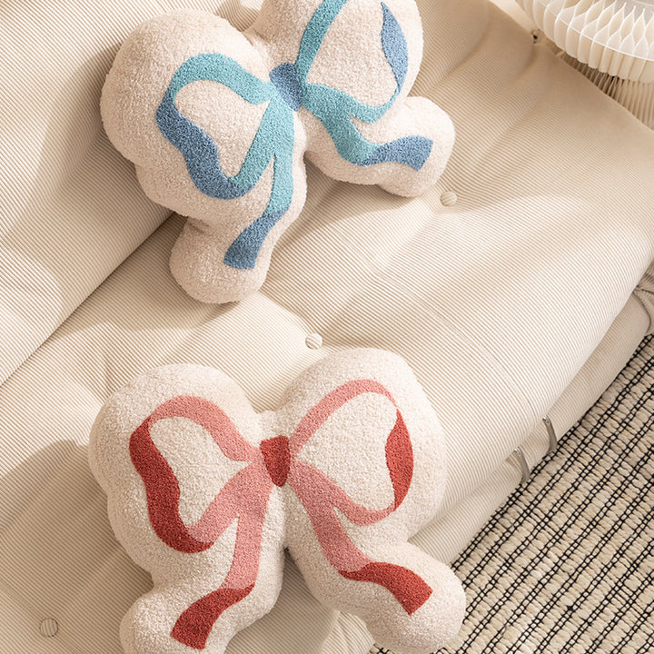 Bow decorative cushion made of boucle with fluffy teddy look