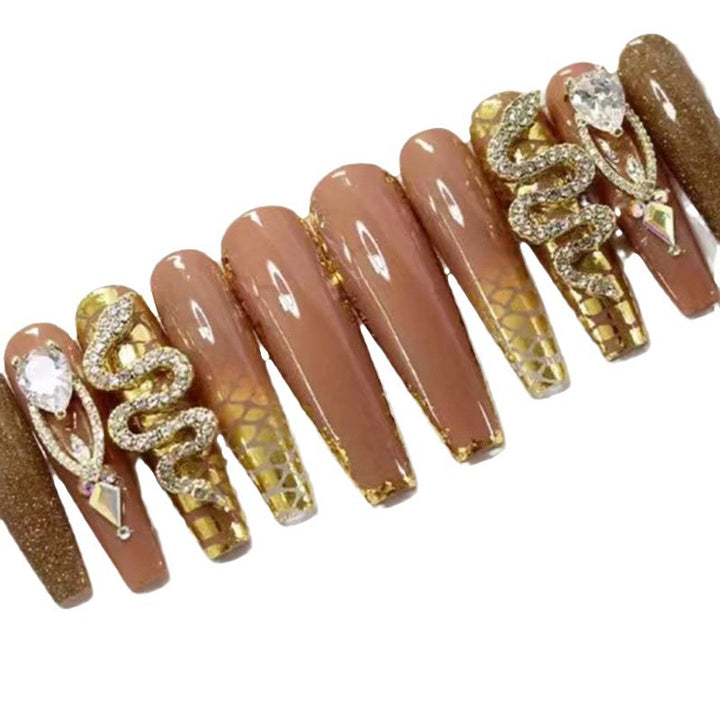 Exclusive stiletto artificial nails with glitter and jewelry accents Kalsten